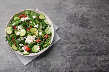 Plate of delicious cucumber salad on grey table, top view. Space for text