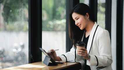 Portrait of a young beautiful Asian woman in a office room, concept image of Asian business woman, modern female executive, startup business woman, business leader woman.