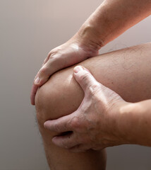A person with knee pain massaging it for relief. Injuries. Arthritis.