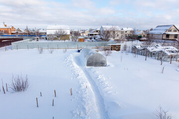 Greenhouse in the vegetable garden in the snow