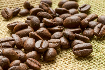 roasted coffee beans on a jute fabric, macro photo
