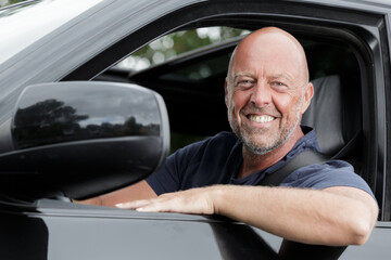 emotional portrait of an active mature man in his car