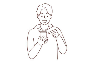 Smiling man using cellphone texting 