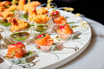 Set of various small appetizers on a buffet table