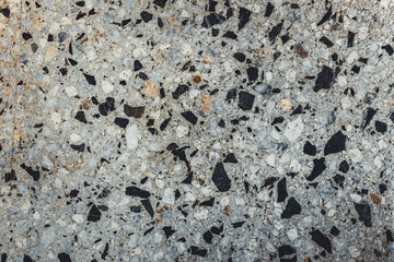 Close-up of grey texture of stones, background. Premium colorful abstract background with dynamic shadow on background, consisting of small stones, gradient colour, artistic texture, epic background