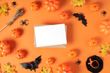 A white sheet of paper on a Halloween background with pumpkins and spiders on an orange background...