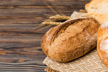 Homemade natural breads. Different kinds of fresh bread as background, perspective view with copy space