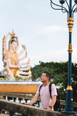 A young man, a tourist admires Buddhist architecture. Koh Samui, Thailand