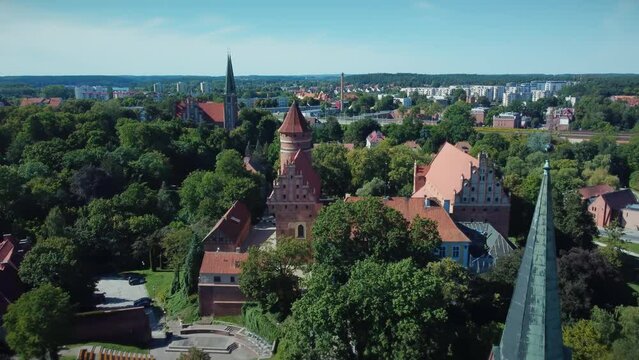 Aerial view of an old catholic cathedral and a medieval castle in a small East European city in Olsztyn Poland