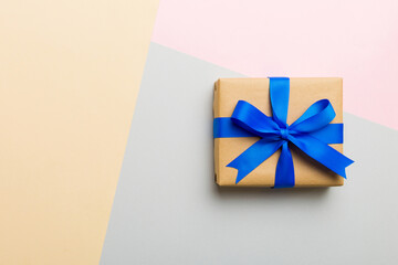 holiday handmade paper present tied blue ribbon bow top view with copy space. Flat lay holiday...