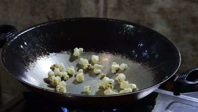 popcorn explodes in the pan. cooking HD videos. snacks for watching movies.