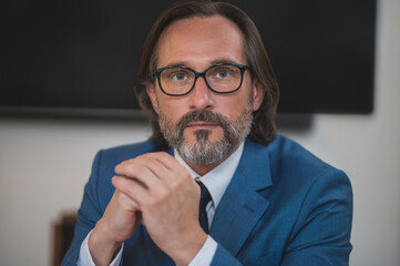 Headshot of a good-looking bearded mature man