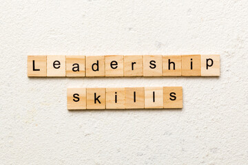 Leadership skills word written on wood block. Leadership skills text on cement table for your desing, concept