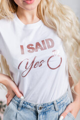 The inscription on the bride's white T-shirt: I said YES. T-shirt for a bachelorette party.