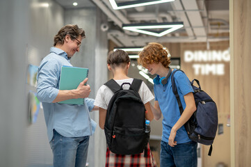 School children in the school corridor looking involved