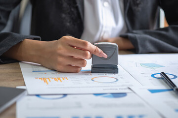 African American businesswoman working in the office using laptops, graphs and office equipment for work.