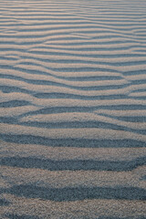 Beach sand. Wavy sand, sand formed by the wind in the form of an embankment. Shady sand. Sandy view from Patara Beach.