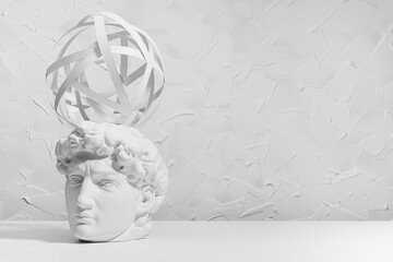 Brainstorming concept with abstract swirl of thoughts over head of white antique statue David in intense thinking and creativity process. College and school education abstract background.