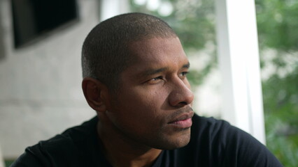 One pensive black man. Thoughtful African American person staring out window in contemplation