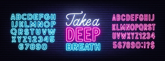 Take a Deep Breath neon quote on brick wall background.