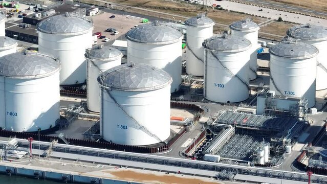 Petroleum oil storage silos. Refinery industrial oil tank container top down aerial drone view. Chemical liquid metal business storage container structure. Overhead view.