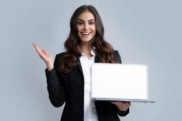 Woman holding laptop with empty mock up screen for copy space. Business women in suit excited...