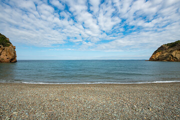 Sunset by the sea. long exposure. Pebble seascape. Sand and pebble beach.Galippoli, Canakkale Turkey. Fishing boat moored by the sea.	