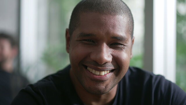 Happy African American man portrait closeup face. A black person smiling at camera. A Brazilian guy