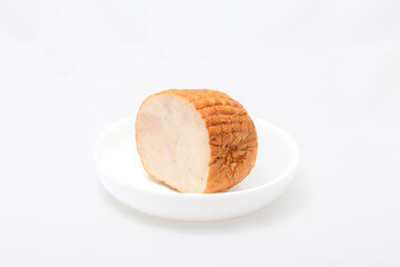 Chicken loaf isolated on white background. Piece of sausage on a white plate