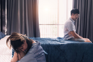 asian couple fight over failure relationship. separated couple with dysfunction marriage depressed together in family house. beautiful young wife upset unhappy husband having a divorce in bedroom