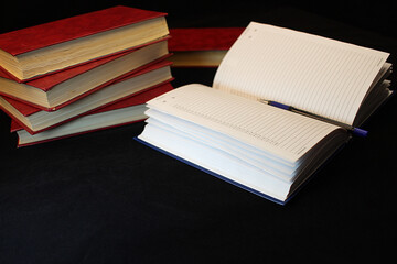 a stack of red books on a black background