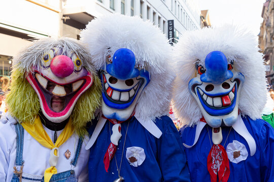 Switzerland, Basel, 8 March 2022.  Close-up of three carnival participants wearing waggis masks