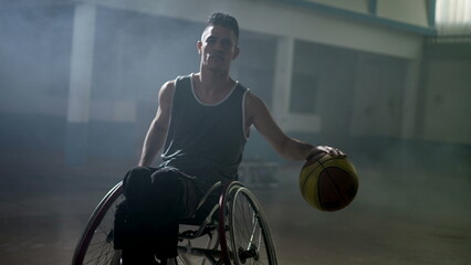 A hispanic disabled basketball player in a wheelchair portrait with serious expression. Determination and motivation concept