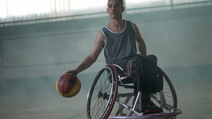 A disabled athlete in wheelchair playing basketball. Handicapped sportman