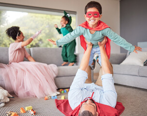 Happy parents and children in costume playing, bonding and having fun together in living room....