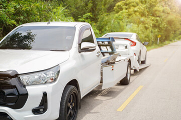 Closeup damaged car truck slides and the white car in the accident on local road with sun flare and...