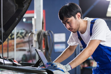 Transportation repair service concept, Repairman auto mechanic using tablet to check for damage...