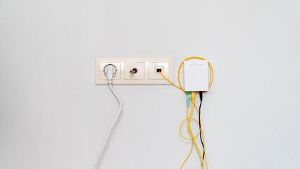 Socket with tangled wires, cables and Internet router on a white background