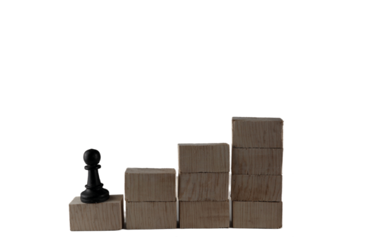 chess pieces on a wooden block. concept of goals of an employee who wants to achieve the highest success