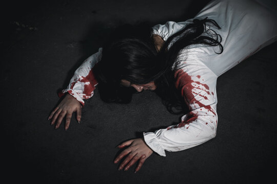 Horror bloodthirsty woman ghost horror she death and scary at dark night in tunnel, The girl was hit by a car and lying died on the road. full of blood left unattended, Happy halloween day festival
