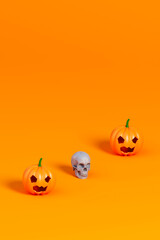 Halloween pumpkin and white skull on orange background.3d illustration