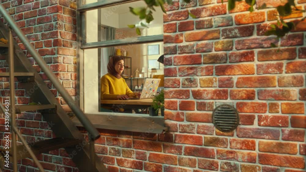 Poster young muslim female using laptop at home. doing remote work during the day. specialist working on co