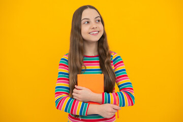Teen girl pupil hold books, notebooks, isolated on yellow background, copy space. Back to school, teenage lifestyle, education and knowledge.