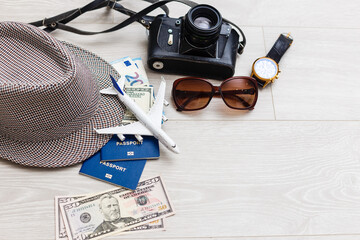 Travel and vacation concept. Trip accessories and items. Airplane toy over passport with airplane tickets. Top view flat lay with copy space