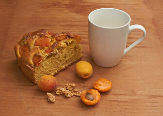 Apricot pie with fresh fruits on a wooden table. High quality photo