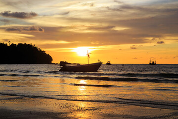   Seascape with beautiful sky in the evening.Dramatic clouds and mirror reflections on water.Twilight sky and cloud with orange sun nature background.Beautiful sunset  and Wooden fishing boat .
