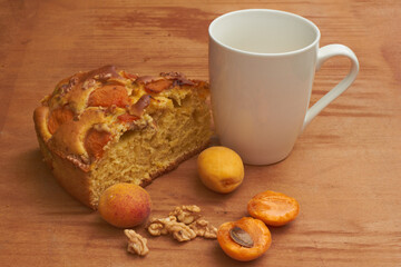 Apricot pie with fresh fruits on a wooden table. High quality photo
