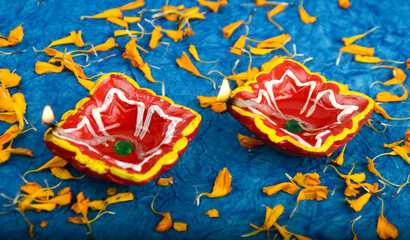 Oil lamps (Clay diya) lit with marigold flowers during diwali celebration.Greeting Card Design Indian Hindu Light Festival called Diwali.
