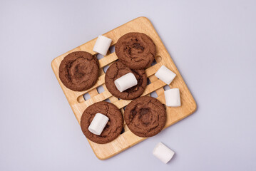 Tasty Homemade Chocolate Chip and Marshmallow Dark Chocolate Cookies on Wooden Tray Blue Background Top View