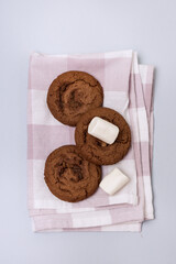 Tasty Homemade Chocolate Chip and Marshmallow Dark Chocolate Cookies Linen Napkin Blue Background Vertical
